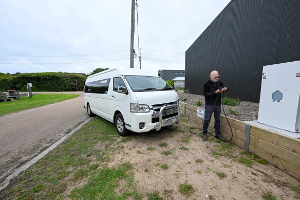 Frank Schrever connecting the bus to the electric charging station at Sandy Point. 