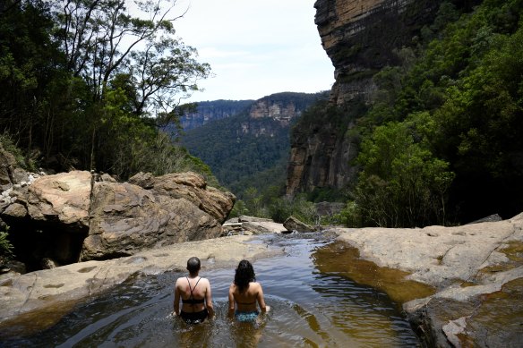 German tourists Virginia Wolf and Hannah Distel escape the heat on Friday in the Blue Mountains.