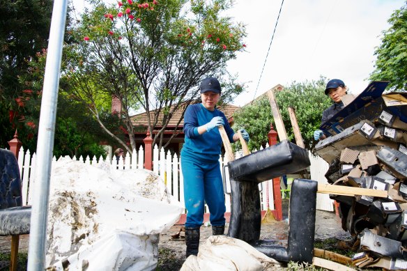 Hoang Nguyen and wife Lam Luong cleaning up their home in Maribyrnong on Saturday.
