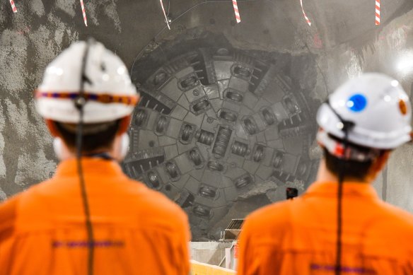 The first of two tunnel-boring machines working on the Cross River Rail project break through to the new Roma Street station cavern on Friday.