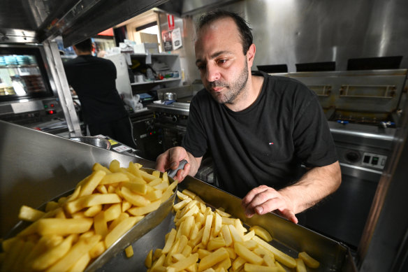 Off The Pier owner Hazem Hazouri cooks up chips at his Williamstown shop.
