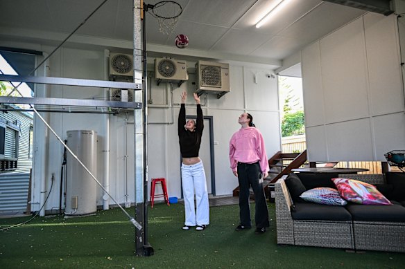 The Lawson sisters playing basketball underneath their newly raised house.