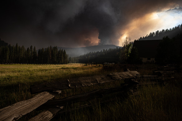 The tranquil scene in the foreground is menaced by a huge rotating fire column. 