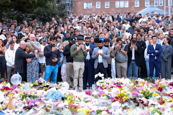 People lay flowers at the Bondi Beach Pavilion on Monday evening.