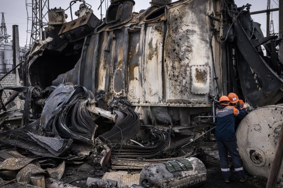 Workers dismantle an auto-transformer which stands completely destroyed after the Ukrenergo high voltage power substation was hit by a missile strike in central Ukraine.