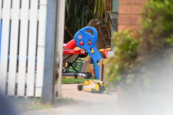 Colourful play equipment, including a tricycle, was scattered in the garden after the fire.