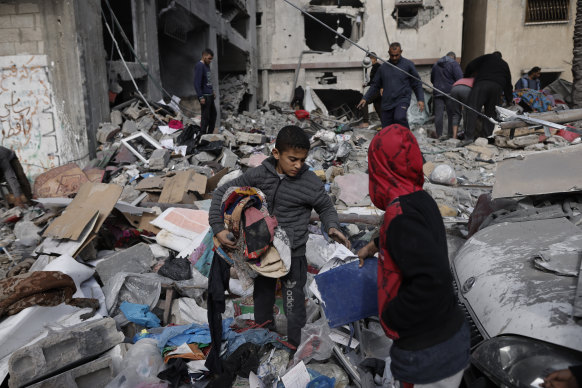 Palestinians salvage their belongings after an Israeli strike in Khan Younis, Gaza Strip, on January 12.
