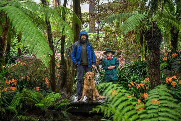Dandenongs resident Chuck Page with his son and dog in the Alfred Nicholas Memorial Gardens on Tuesday. 
