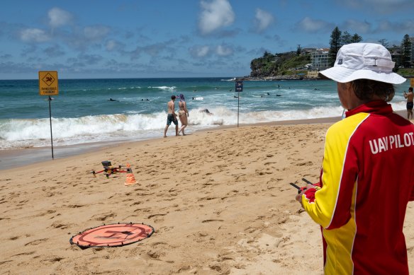 Michael Coventry from Surf Life Saving NSW’s unmanned aerial vehicle division operates a drone with a speaker attachment to warn swimmers of shark danger.