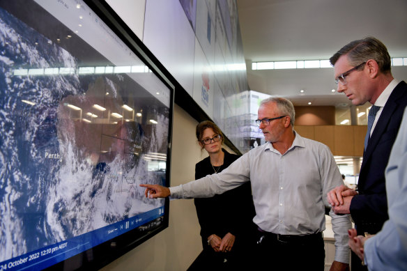 NSW Premier Dominique Perrottet, Emergency Services Minister Steph Cooke and the Bureau of Meteorology’s Steven Bernasconi (centre) discuss the state’s flood emergency at the Rural Fire Service headquarters at Sydney Olympic Park.