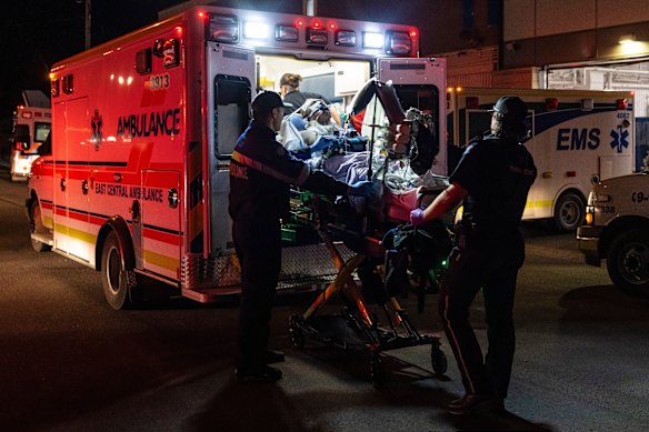 Paramedics load an injured person into an ambulance at the Wainwright Health Centre.