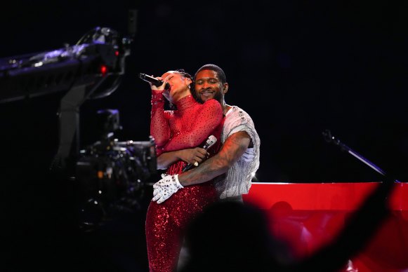 Alicia Keys and Usher embrace during the Super Bowl half-time show.