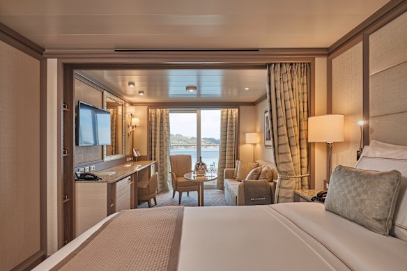 A curtain divides the bed and the sitting room in the neutral-hued Veranda Suite.