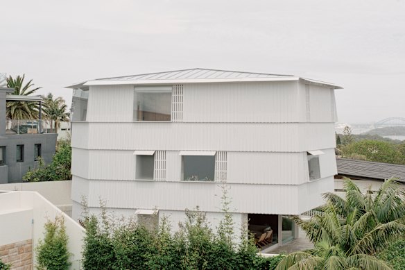The external cladding also features a pointed edge across all three floors of the house.