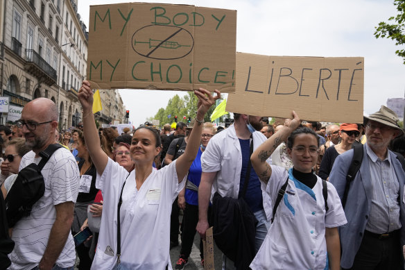 Nurses hold placards as they march during an anti-vaccine protest in Paris on the weekend. 