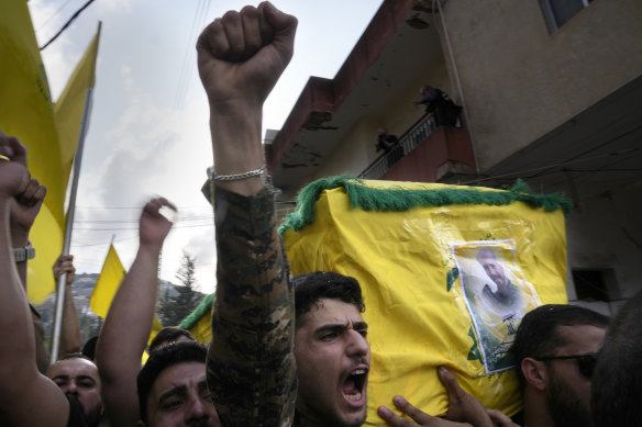 October 2023: A Hezbollah fighter carries the coffin of another fighter who was killed by Israeli shelling.