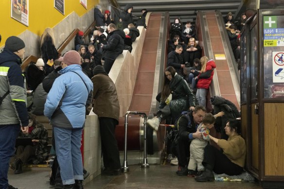 People gather in a subway station being used as a bomb shelter during a Russian rocket attack in Kyiv, Ukraine.