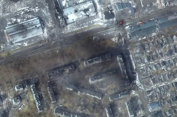 A satellite image provided by Maxar Technologies shows damage to apartment buildings and fires with damage in the Zhovtnevyi district in western Mariupol.