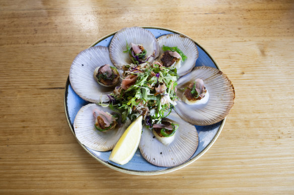 The seared half shell scallops with wakame, pickled ginger, herby bits and a sesame and soy dressing are the star of the meal.
