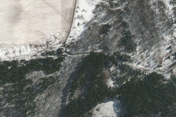 The satellite image provides by Maxar shows troops and equipment deployed to trees and towed artillery in firing position, north-west of Kyiv. 