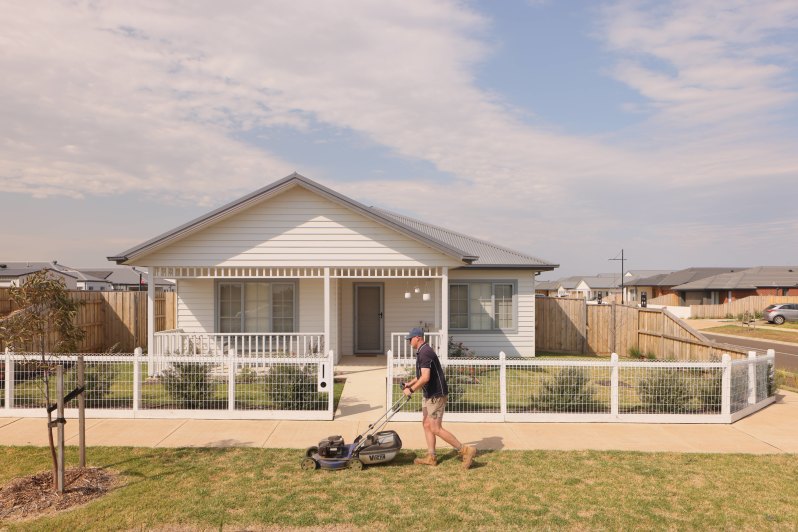 Freeing up Sunday afternoons: A maintenance worker mows the lawn outside a Resimax BTR house in the company’s Eynesbury community in Melbourne’s western suburbs.