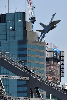 A Royal Australian Air Force EA-18G Growler flies over the Brisbane skyline as part of the final rehearsal for Riverfire.