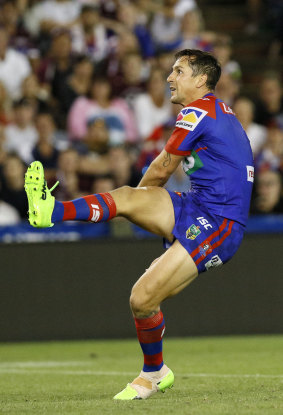 Fine debut: Mitchell Pearce kicks the winning field goal in golden-point. extra time