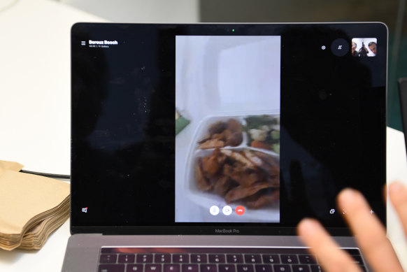 Boochani had to ask the guard to let him out of his room to collect his fried chicken lunch, seen here on Skype.