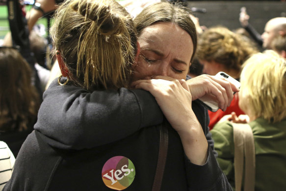 "Yes" campaign supporters  react as the results of the votes are announced.