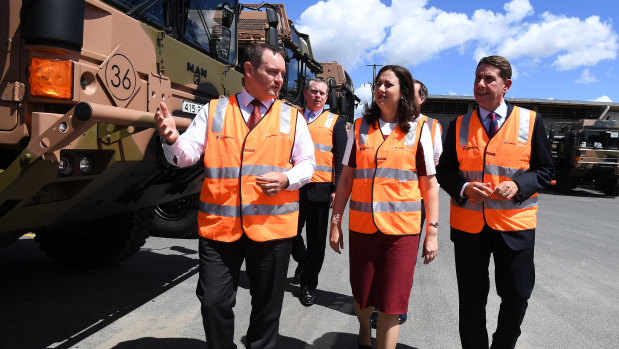 Queensland Premier Annastacia Palaszczuk (centre) and Minister for State Development Cameron Dick (right) are given a tour by Rheinmetall Defence Australia managing director Gary Stewart at the Rheinmetall Man Military Vehicles facility in Brisbane.