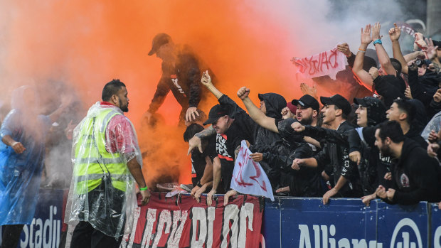 Tensions flare: The Red and Black Bloc react after an Oriol Riera goal.