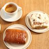 Coffee and baked goods at Hector’s Bakery, including the cinnamon bun with “Cinnabon vibes”(right).