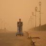 A man pushes a cart during a sandstorm in Baghdad, Iraq.
