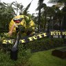 A giant golf ball sign at a putt putt course is toppled over as a result of strong winds from ex-tropical cyclone Alfred at Mermaid Beach on Sunday.