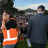 Rally organiser Sarah Williams looks away as Prime Minister Anthony Albanese speaks at the event calling for an end to violence against women, in Canberra yesterday.