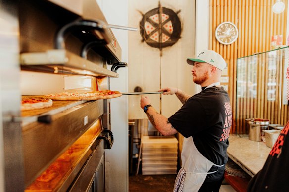 Pizzas are cooked in an electric oven. 