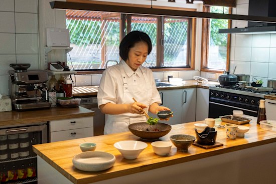 Chef Chae prepares food in the kitchen.