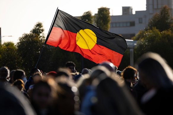 An Aboriginal flag flying at the candlelight vigil for Cassius Turvey.