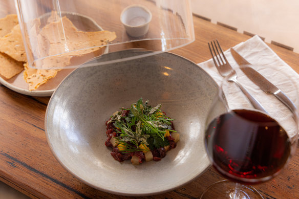 Kangaroo tartare arrives under a smoke-filled dome.