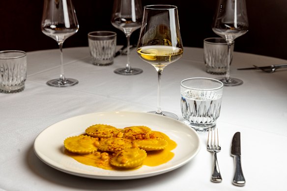 Spanner crab ravioli is served with a fermented pumpkin bisque.