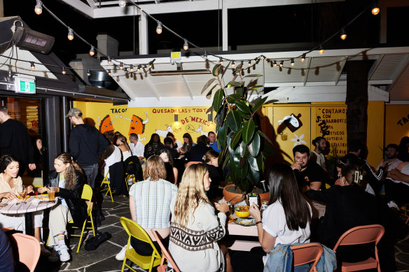 Ricos Tacos’ colourful courtyard by night.
