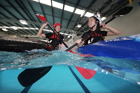 Frankston High School students Archer Gibson and Ava Bryant learning to kayak during an outdoor education lesson in their school swimming pool.
