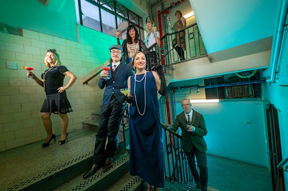 Samantha Schrader (centre), Stephen McLaughlan (right) and Anna Prifti (far left) and other tenants hold a 1920s-style party to  celebrate the centenary of artistic hub the Nicholas Building in Melbourne.
