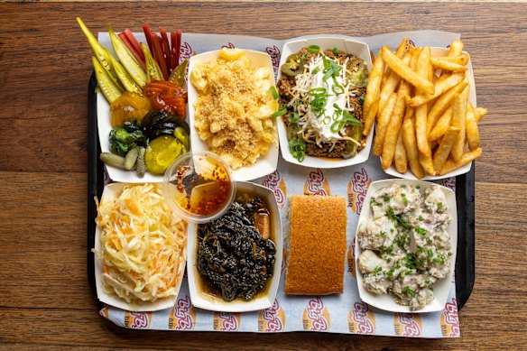 Southern Grace’s impressive line-up of side, clockwise from top left: Pickles, macaroni cheese, Texas-style chilli con carne, chips, potato salad, cornbread, greens and coleslaw.