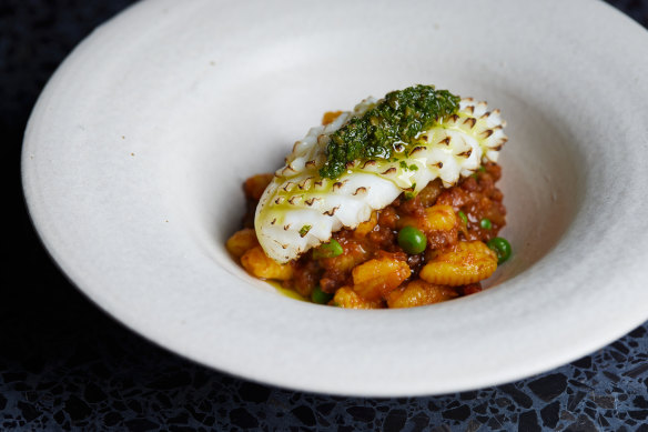 Cuttlefish with saffron, red wine and vegetables and tomato, tossed with house-made saffron cavatelli pasta and spring peas. 