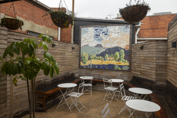 The courtyard mosaic is a recreation of a painting by the bar’s namesake.