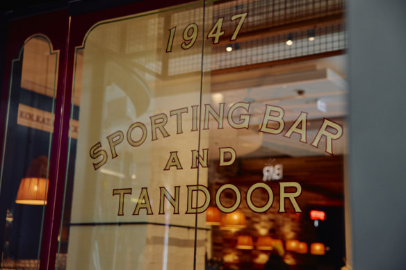 Kolkata Cricket Club spans two distinct spaces: a restaurant and a sporting bar showing cricket matches.