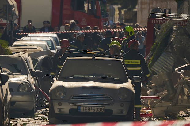 Firefighters work at the scene following a powerful blast that caused a building to collapse and injured at least two people in Athens’ Plaka district, Friday, Sept. 25, 2026