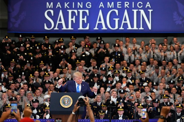 President Donald Trump dancing on stage for a crowd of police officers in New York state.