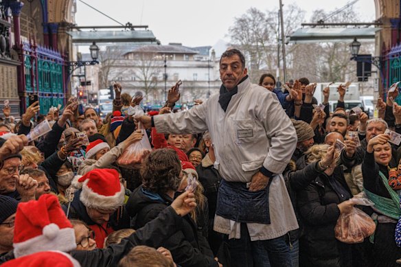 The annual Christmas Eve meat sale at London’s Smithfield Market. For the past century, traders have sold off their surplus meat on December 24.